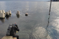 Laying gabion mattresses of the Triton system and tetrapods.